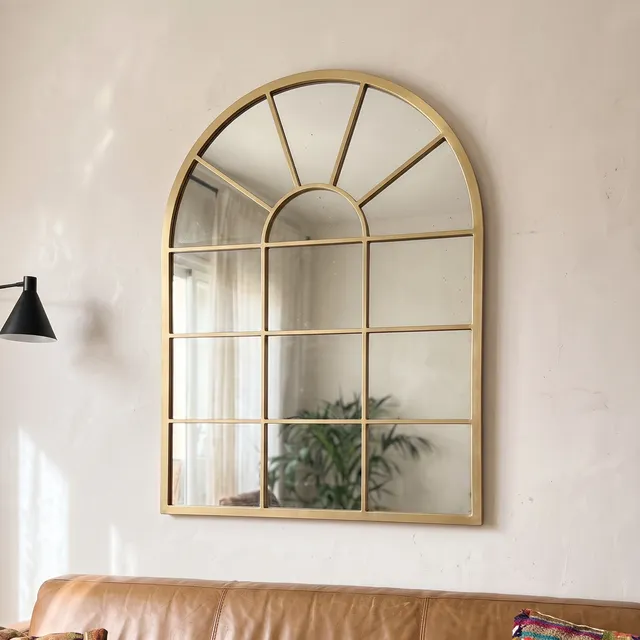 Miroir Verrière Arche cadre métal doré dans un salon